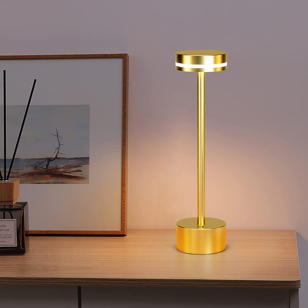Elegant gold LED cordless lamp providing portable and stylish illumination for contemporary spaces